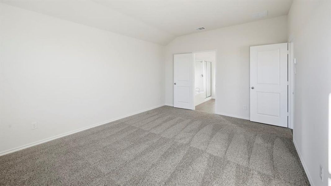 Unfurnished room with lofted ceiling and carpet Unfurnished room with lofted ceiling and carpet