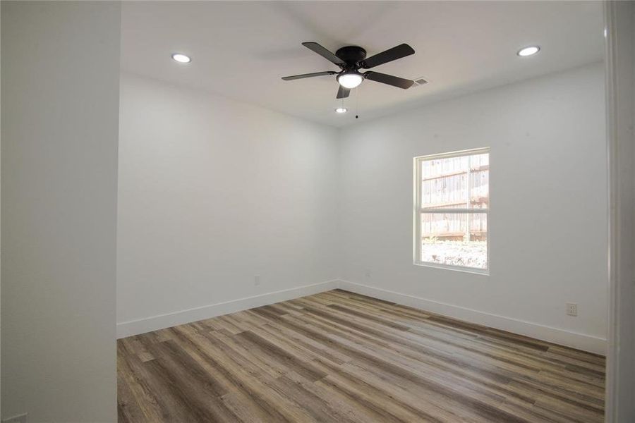 Unfurnished room with ceiling fan and wood-type flooring