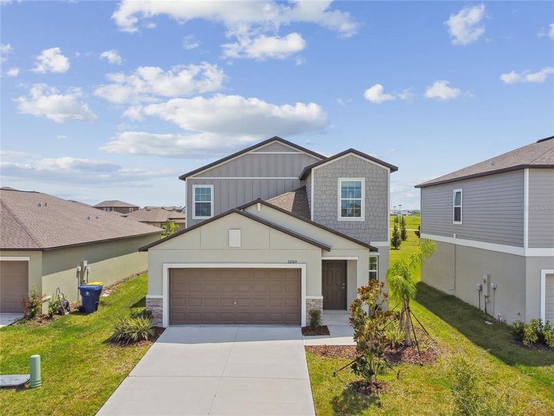 Front exterior of a new home in , San Antonio, FL, highlighting curb appeal (Image 1).