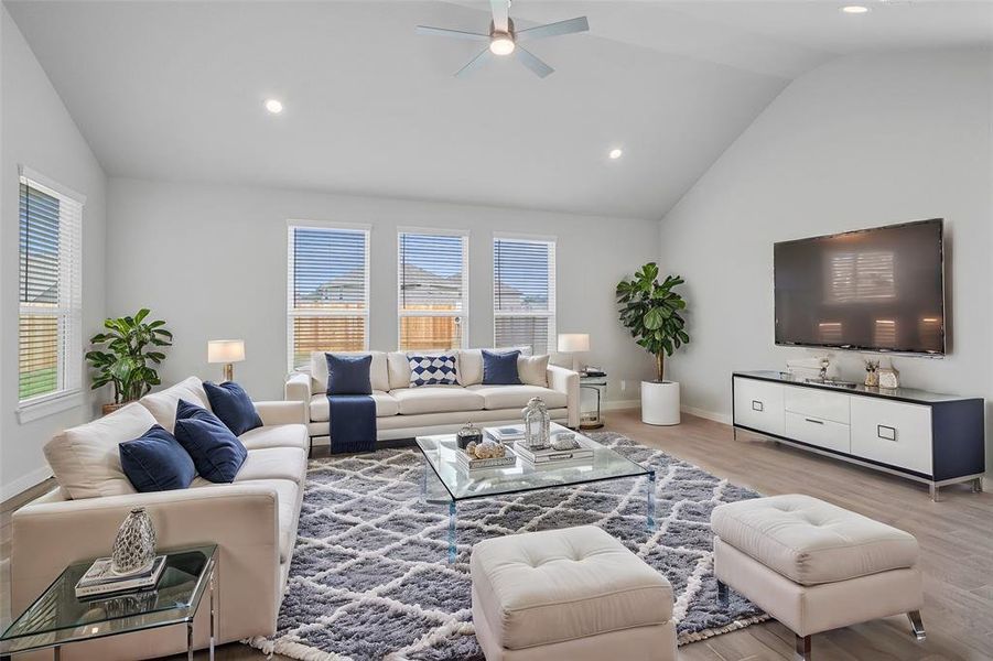 Gather the family and guests together in your lovely family room! Featuring high ceilings with ceiling fan, recessed lighting, custom paint, gorgeous tile floors and large windows that provide plenty of natural lighting throughout the day.