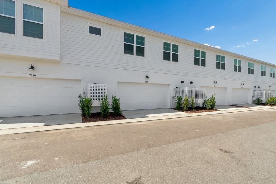 Exterior details and patio area of a home in Emerald Landing at Waterside at Lakewood Ranch – Towns, Sarasota (Image 3).