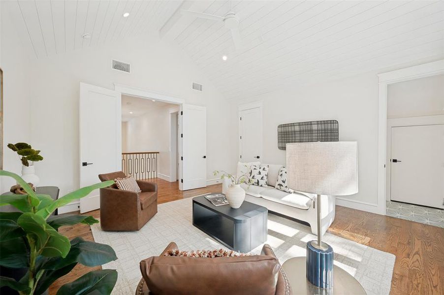 Vaulted ceiling featuring white tongue-and-groove paneling