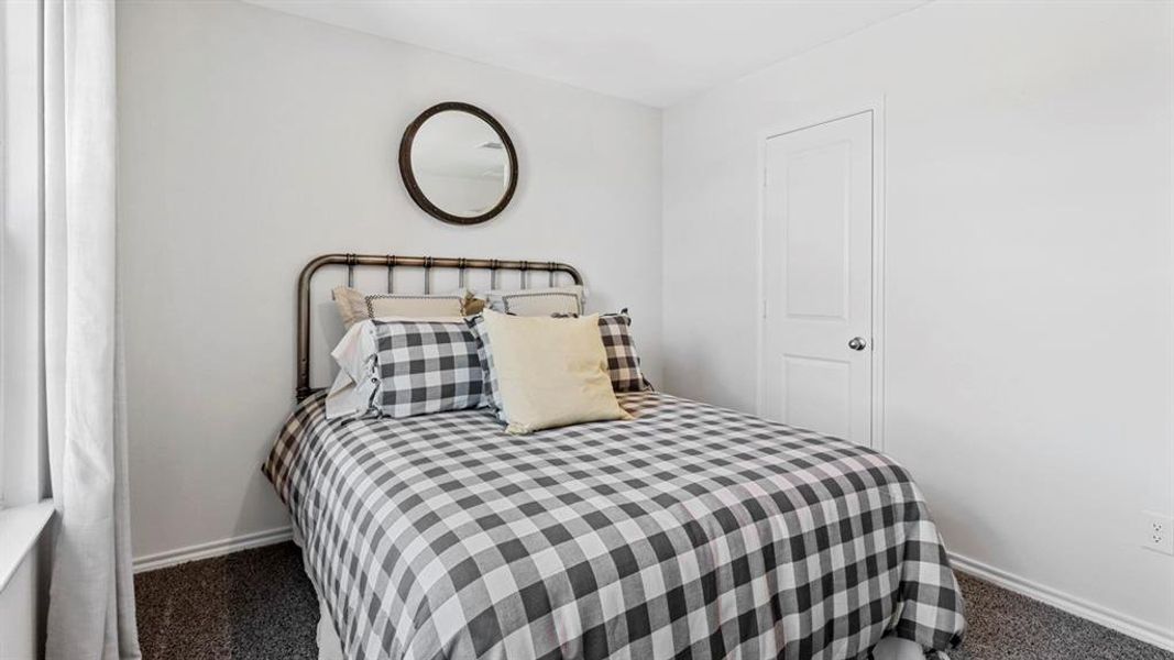 Carpeted bedroom with baseboards