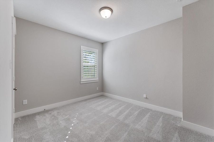 Second bedroom upstairs with plantation shutters