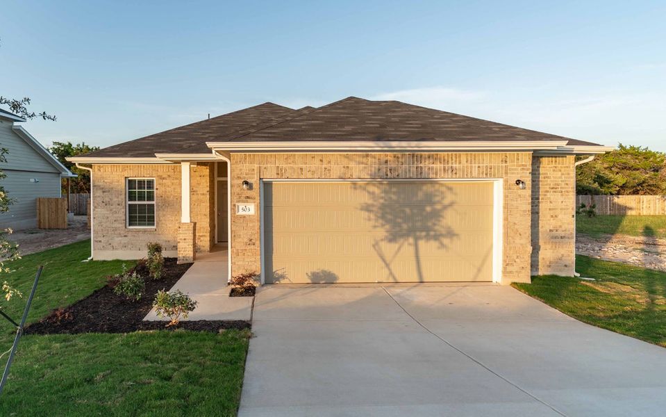 Front exterior of a new home in Grande Estates, Bertram, TX, highlighting curb appeal (Image 1).