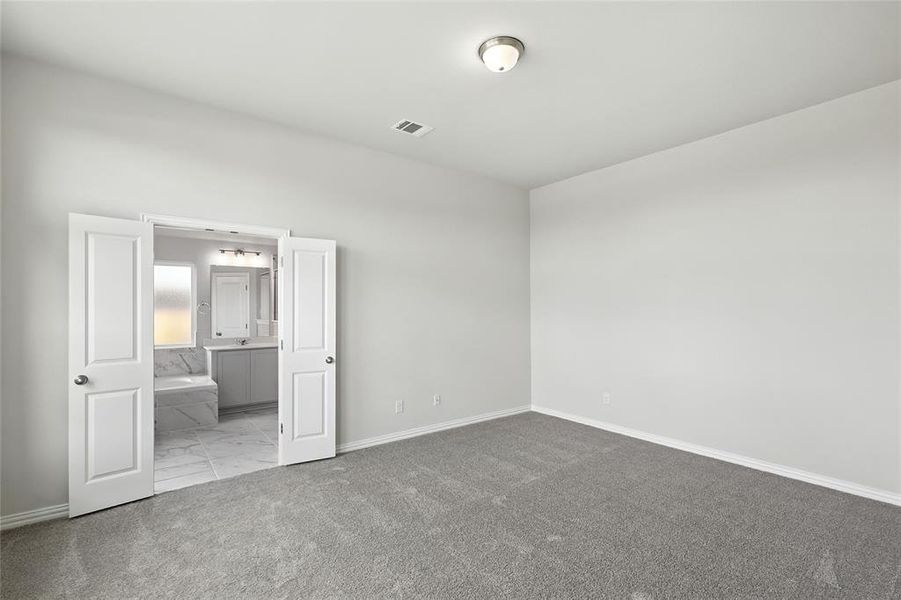 Full bathroom featuring lofted ceiling, a marble finish shower, a garden tub, light marble finish floors, and two vanities Full bathroom featuring lofted ceiling, a marble finish shower, a garden tub, light marble finish floors, and two vanities