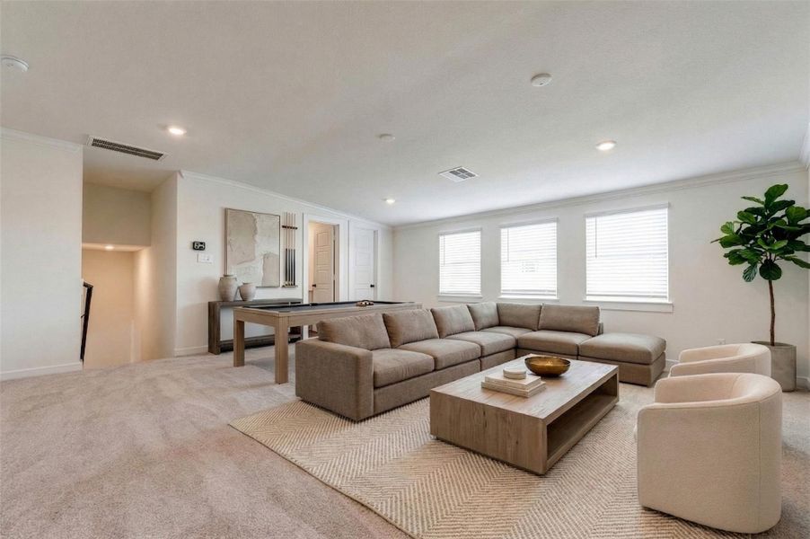 This expansive upstairs game room offers incredible flexibility for entertaining, relaxing, or creating the perfect media space. Plush carpeting and neutral tones provide comfort and versatility, while multiple windows bring in natural light, enhancing the bright, open feel. With ample space for a sectional, game tables, or a home theater setup, this room is ideal for gatherings, hobbies, or a private retreat away from the main living areas. This photo is virtually staged.