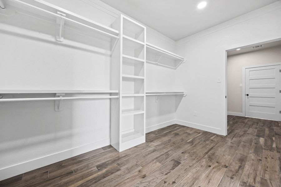 Spacious closet with dark wood-style floors Spacious closet with dark wood-style floors