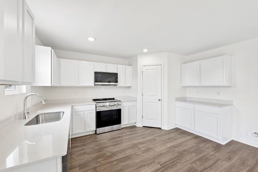 A kitchen with white cabinets. A kitchen with white cabinets.