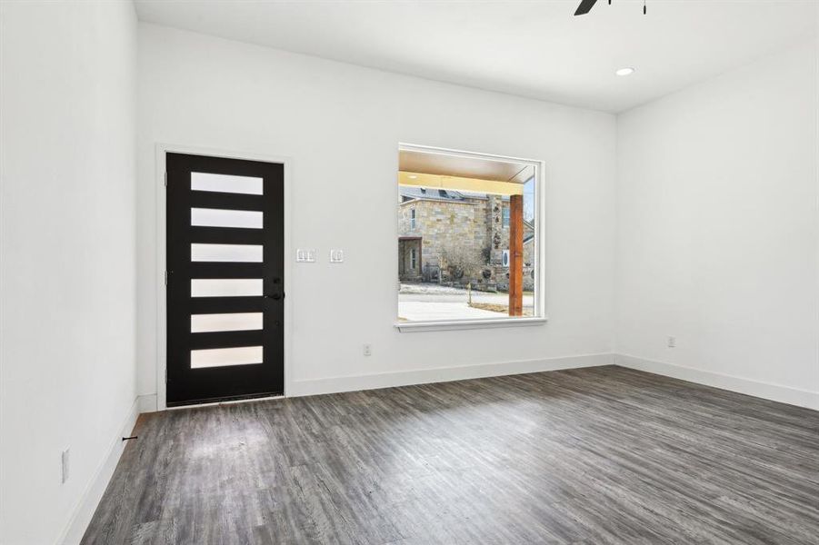 Entrance foyer featuring wood finished floors, a ceiling fan, and baseboards