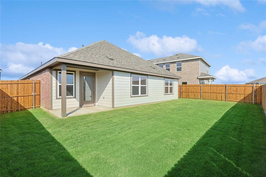 Back of house featuring a yard and a patio