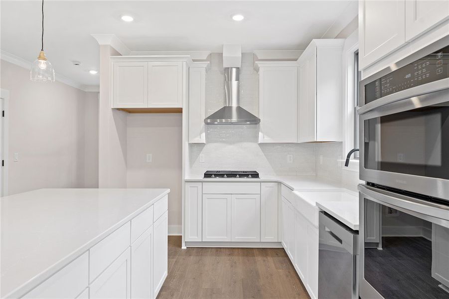 This bright kitchen features sleek white cabinetry