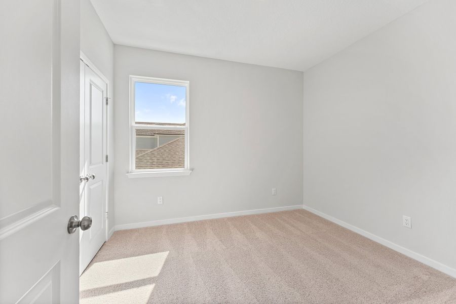 Lot 20 Ponderosa II Guest Bedroom with Window and Double Closet Doors at Camden Woods in Kingsland, GA