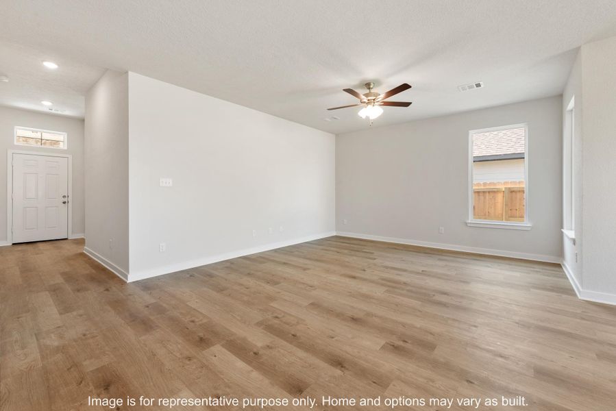 Spare room with light wood-style flooring, a ceiling fan, and a textured ceiling