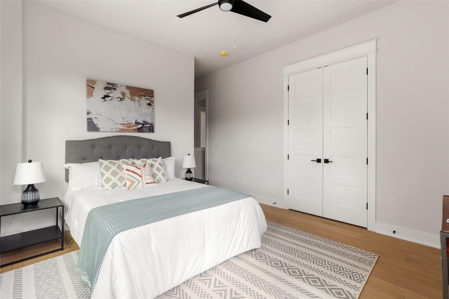 Bedroom featuring wood finished floors, ceiling fan, and a closet Bedroom featuring wood finished floors, ceiling fan, and a closet