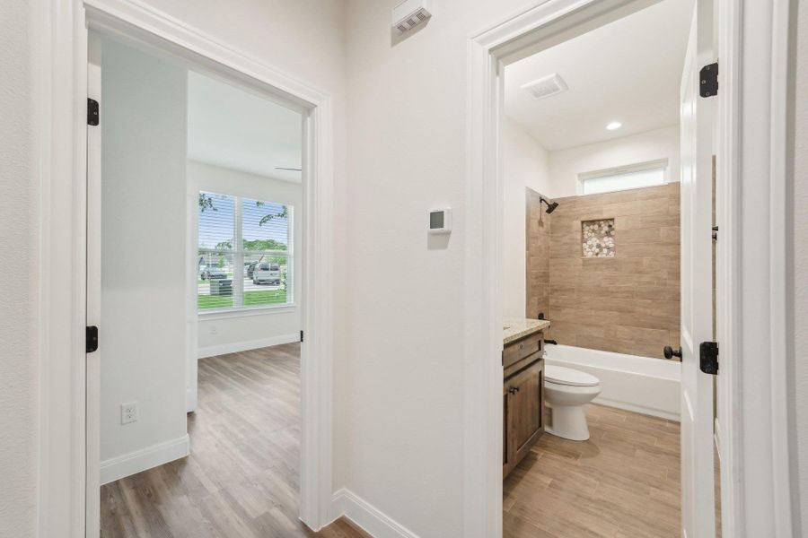 Bathroom with baseboards, toilet, vanity, and tile wood style floors Bathroom with baseboards, toilet, vanity, and tile wood style floors