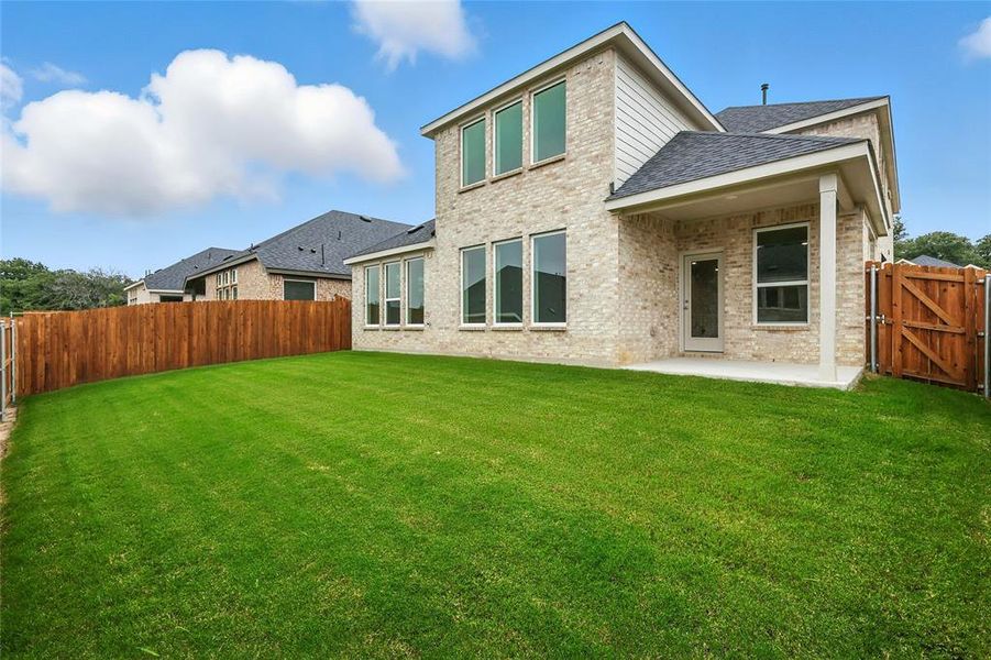 Back of house featuring a gate, a patio area, brick siding, a fenced backyard, and a shingled roof Back of house featuring a gate, a patio area, brick siding, a fenced backyard, and a shingled roof