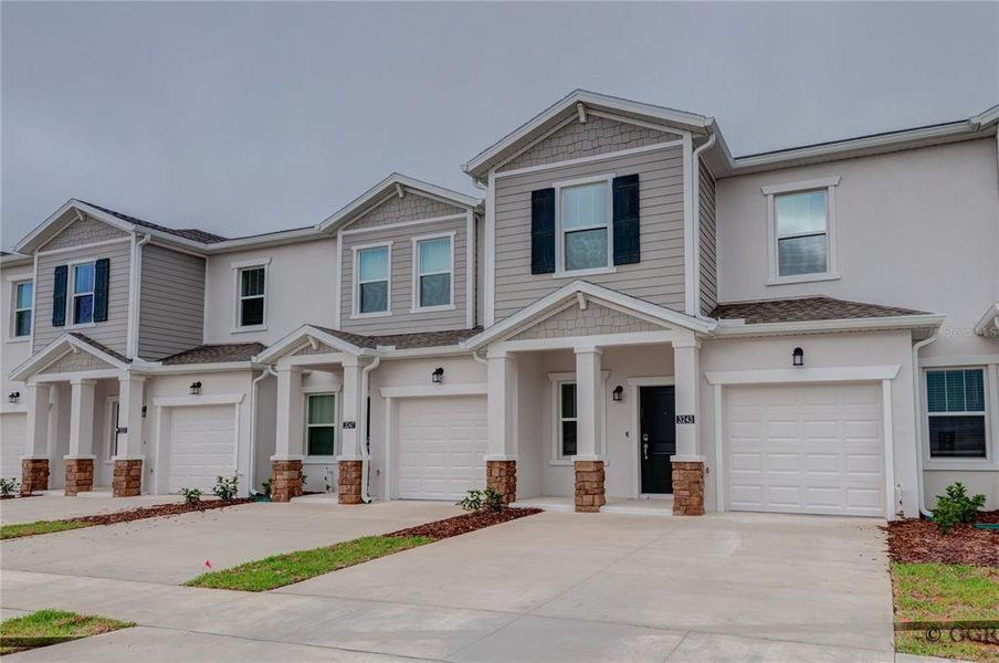 Front exterior of a new home in , Davenport, FL, highlighting curb appeal (Image 15).