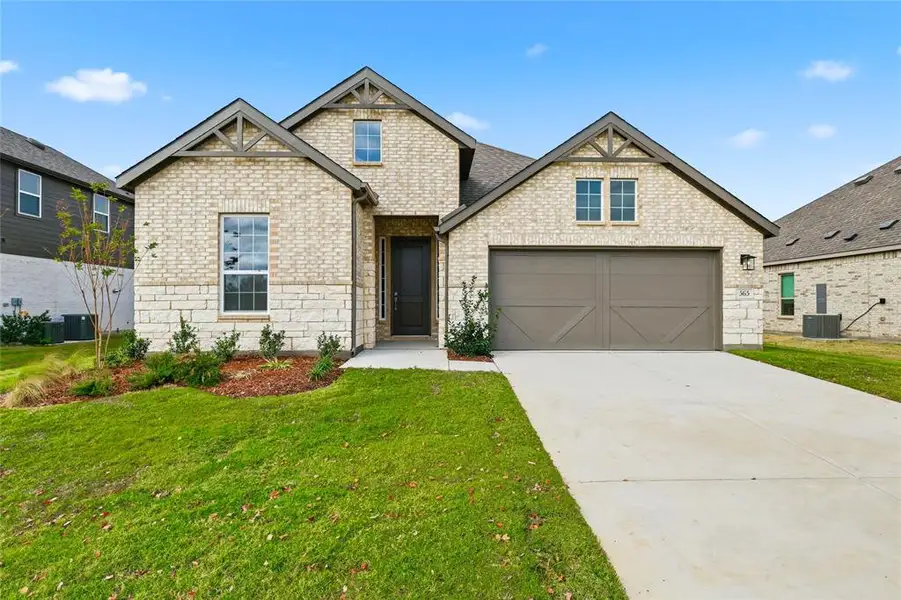 Craftsman house featuring concrete driveway, brick siding, a front yard, and a garage Craftsman house featuring concrete driveway, brick siding, a front yard, and a garage
