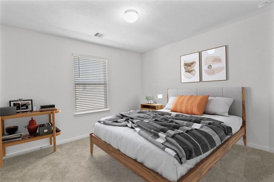 Secondary bedroom features plush carpet, custom paint and a large window with privacy blinds.