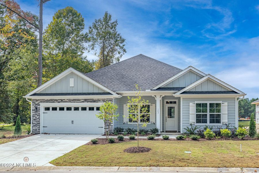 Front exterior of a new home in River Village Square in River Landing, Wallace, NC, highlighting curb appeal (Image 1).