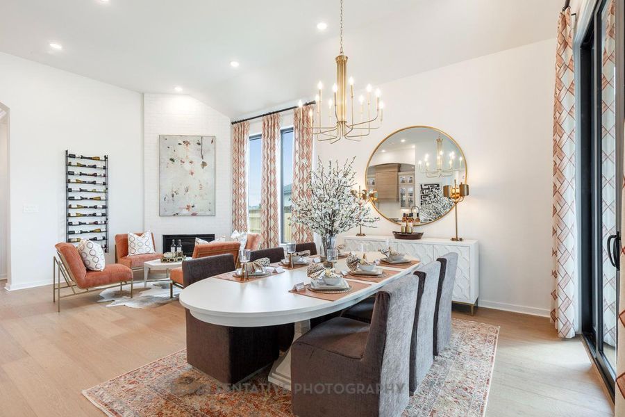 Dining area with light wood-style floors, a chandelier, recessed lighting, and vaulted ceiling Dining area with light wood-style floors, a chandelier, recessed lighting, and vaulted ceiling