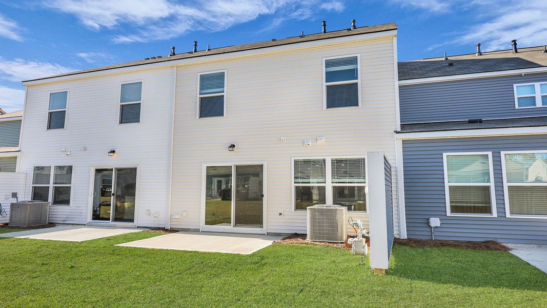 Exterior details and patio area of a home in Pine Hills Townhomes at Cane Bay, Summerville (Image 3). Exterior details and patio area of a home in Pine Hills Townhomes at Cane Bay, Summerville (Image 3).