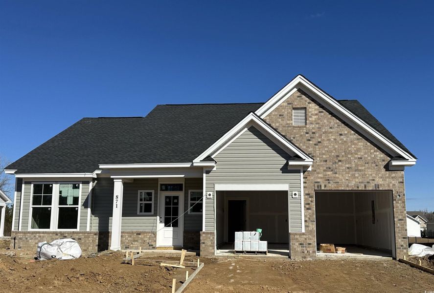 View of front of house with covered porch, brick siding, and roof with shingles View of front of house with covered porch, brick siding, and roof with shingles