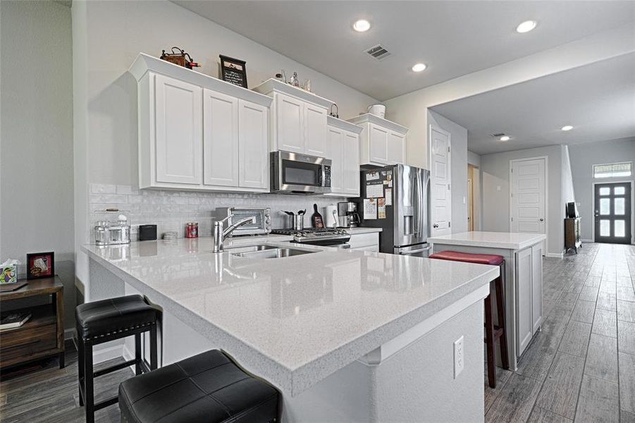 Kitchen featuring white cabinetry