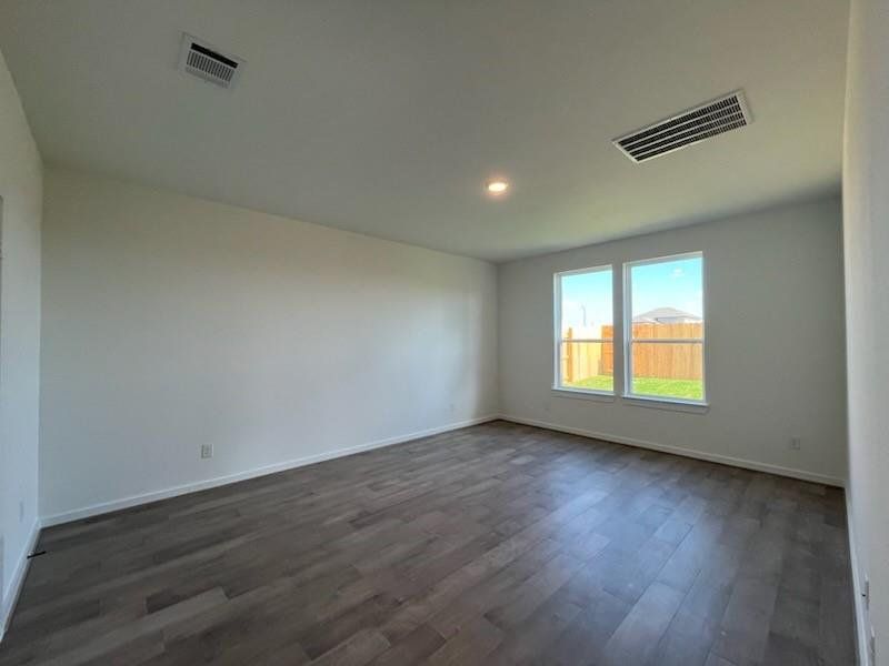 The main bedroom features beautiful wood floors, adding warmth and elegance to the space. With no carpet, it offers a clean, modern look that’s easy to maintain.