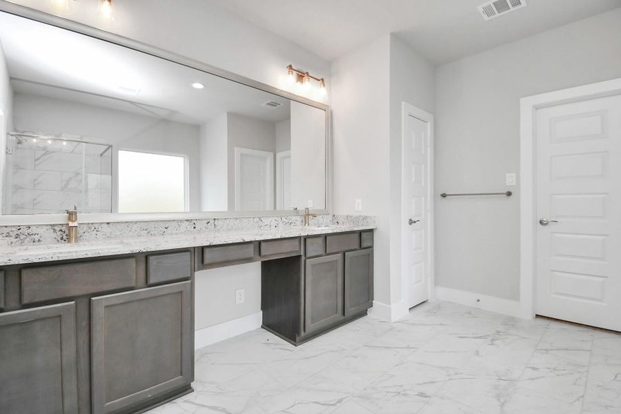 Indulge in the luxurious ambiance of this primary ensuite, reminiscent of a personal spa retreat. Sample photo of completed home with similar floor plan. Actual colors and selections may vary. Indulge in the luxurious ambiance of this primary ensuite, reminiscent of a personal spa retreat. Sample photo of completed home with similar floor plan. Actual colors and selections may vary.