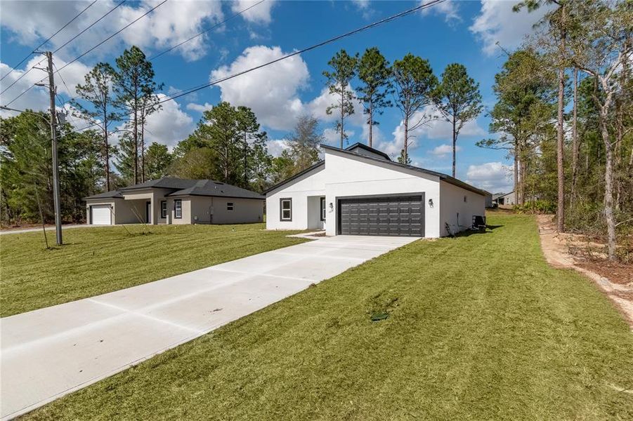 Front exterior of a new home in , Citrus Springs, FL, highlighting curb appeal (Image 26). Front exterior of a new home in , Citrus Springs, FL, highlighting curb appeal (Image 26).