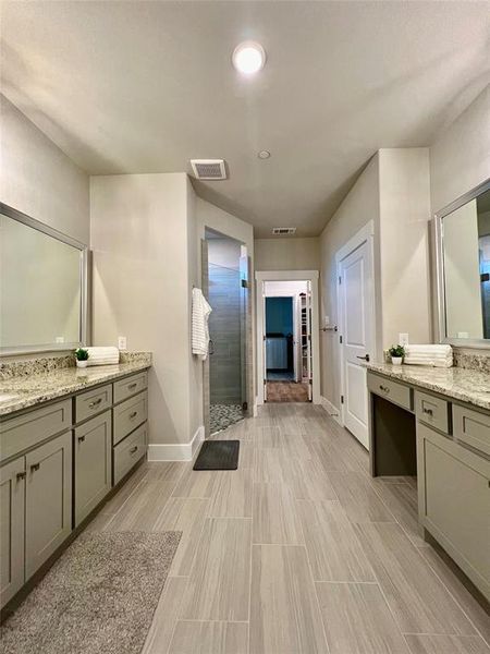 This beautiful Ensuite Primary Bathroom with 2 granite vanities and sinks and an over sized shower containing a seat (a wheel chair would fit into shower, if needed). Private water closet, linen closet, built to perfection!