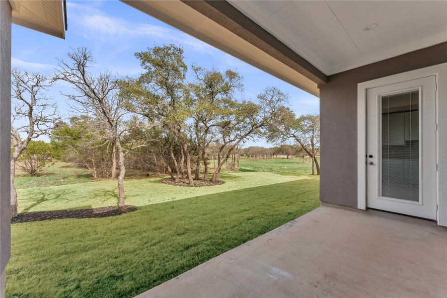 View of grassy yard with a patio