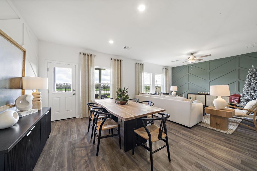 A large living room with a large table and chairs. A large living room with a large table and chairs.