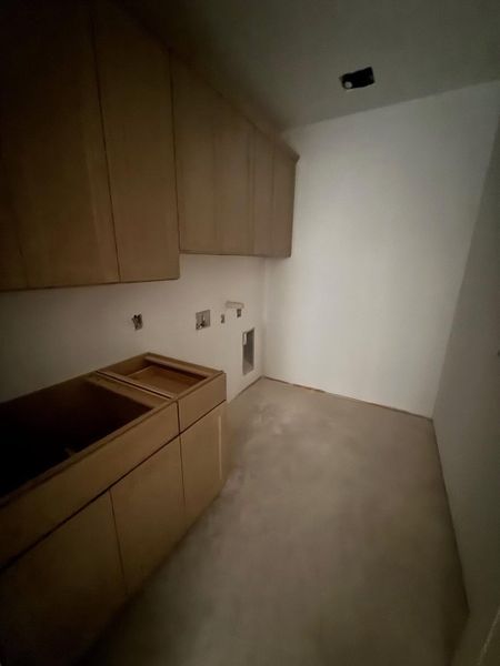 Laundry area featuring hookup for a washing machine and cabinet space