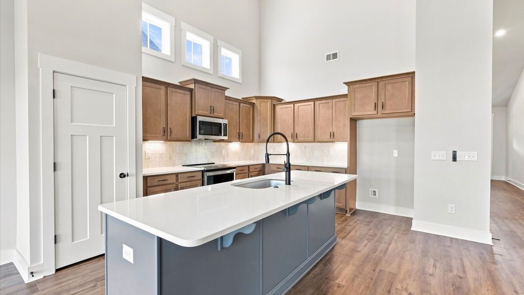 Tasteful kitchen with a streamlined island and modern finishes in a first-class DRB Homes design