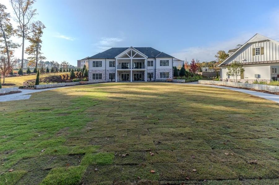 View from back of the clubhouse - immense community with several spacious lawns and beautiful landscaping, all maintained by HOA.