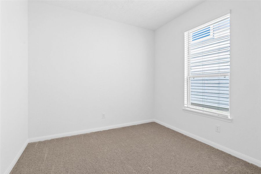 Secondary bedroom features plush carpet, neutral paint, a large window with privacy blinds, and ample closet space. Secondary bedroom features plush carpet, neutral paint, a large window with privacy blinds, and ample closet space.