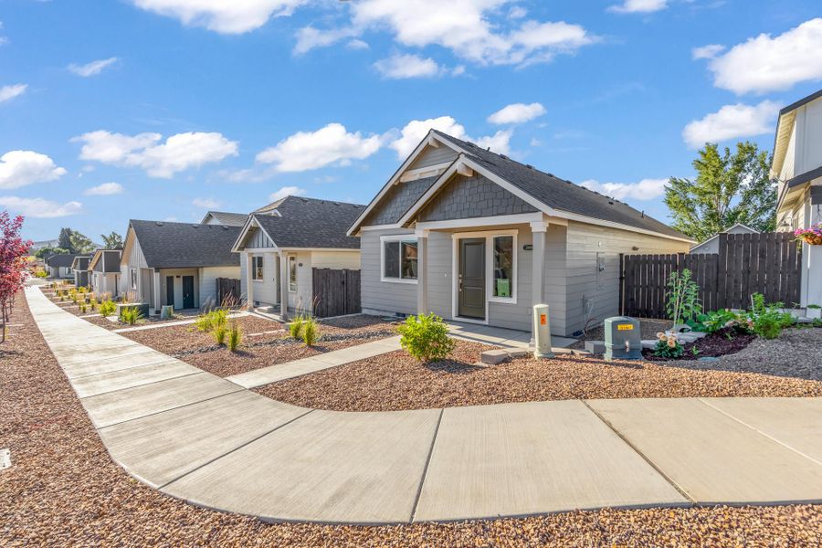 Front exterior of a new home in Feather Ridge, Redmond, OR, highlighting curb appeal (Image 24).