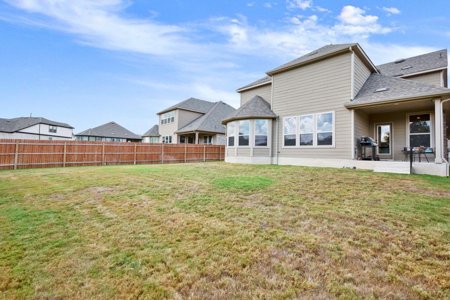 Rear view of house featuring a shingled roof, a patio area, and a fenced backyard Rear view of house featuring a shingled roof, a patio area, and a fenced backyard
