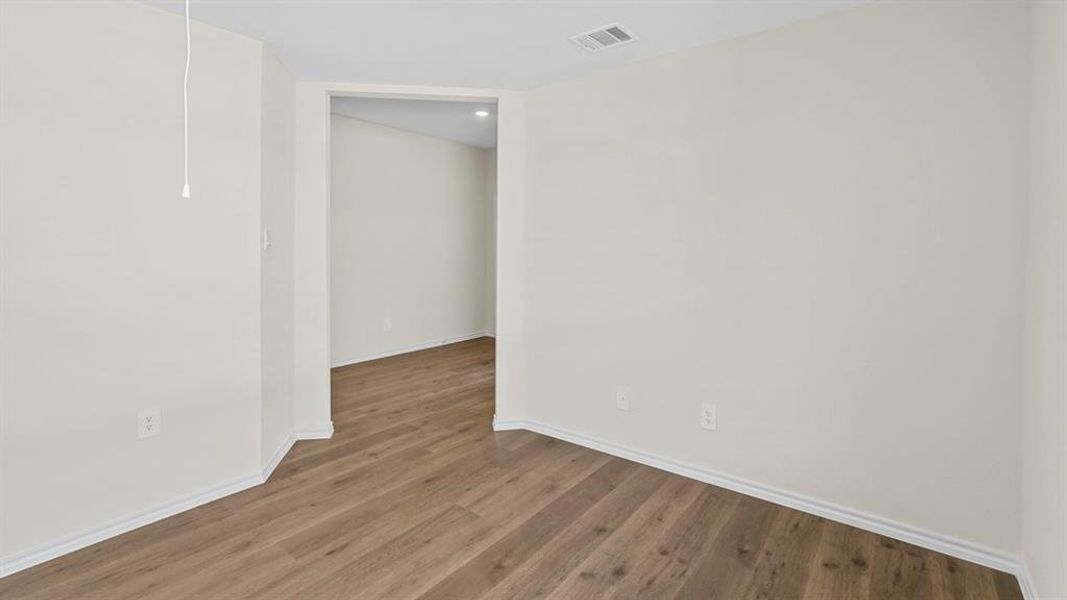 Unfurnished room featuring wood finished floors and baseboards