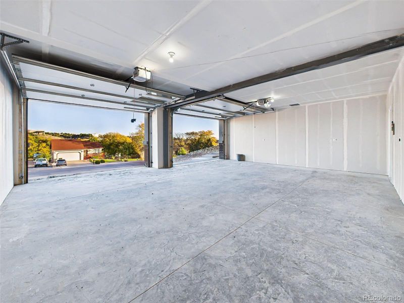 Massive finished 21' x28' garage with high ceilings and room for vehicles, storage, or workshop setup. Massive finished 21' x28' garage with high ceilings and room for vehicles, storage, or workshop setup.