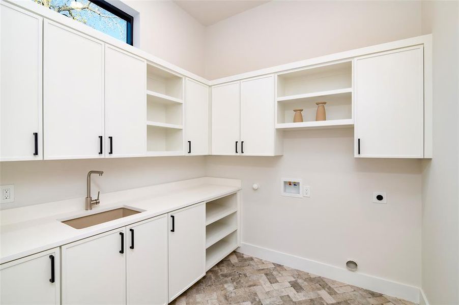 Laundry room with gas dryer hookup, cabinets, sink, hookup for a washing machine, and hookup for an electric dryer