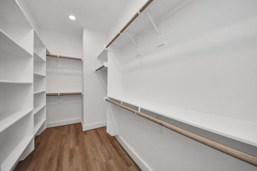 Discover your dream wardrobe space in this spacious walk-in closet, featuring sleek shelving and abundant hanging space, perfect for organizing your fashion treasures.