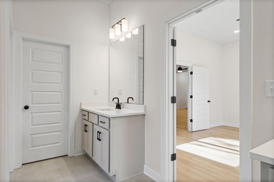 Bathroom featuring vanity and baseboards Bathroom featuring vanity and baseboards