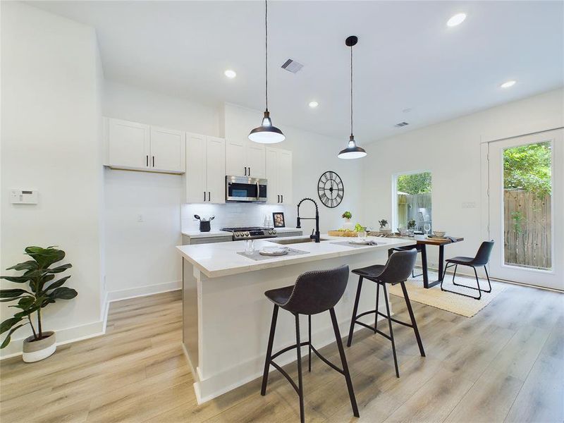 Gorgeous kitchen island with extra seating area. Model home photos, finishes and floor plan MAY VARY!