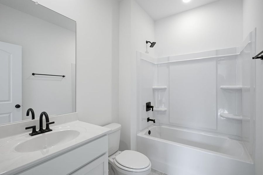 A bathroom with a sink toilet and bathtub.