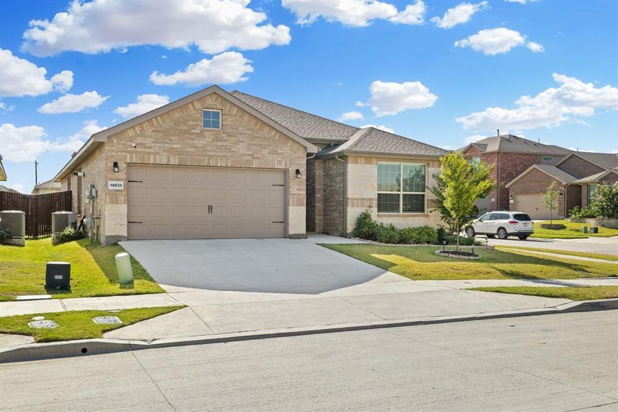 Ranch-style home featuring brick siding, driveway, and a garage