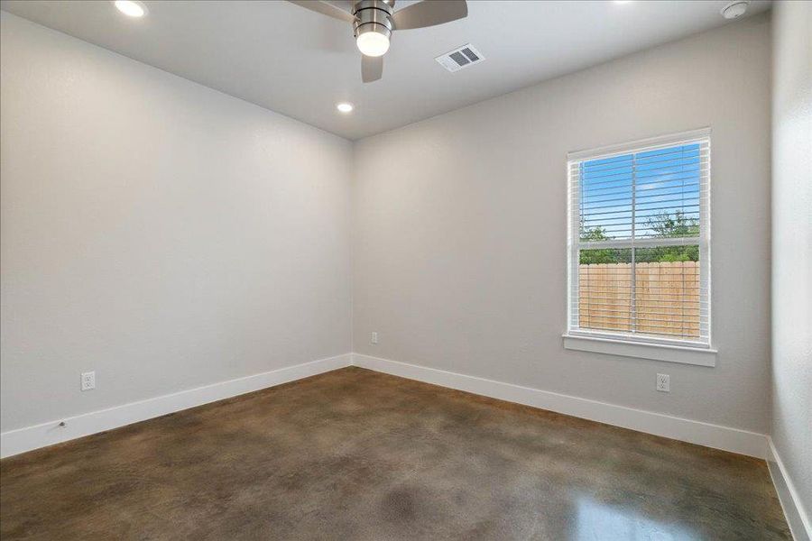 Another nice-sized bedroom with a backyard view and concrete flooring throughout. Another nice-sized bedroom with a backyard view and concrete flooring throughout.